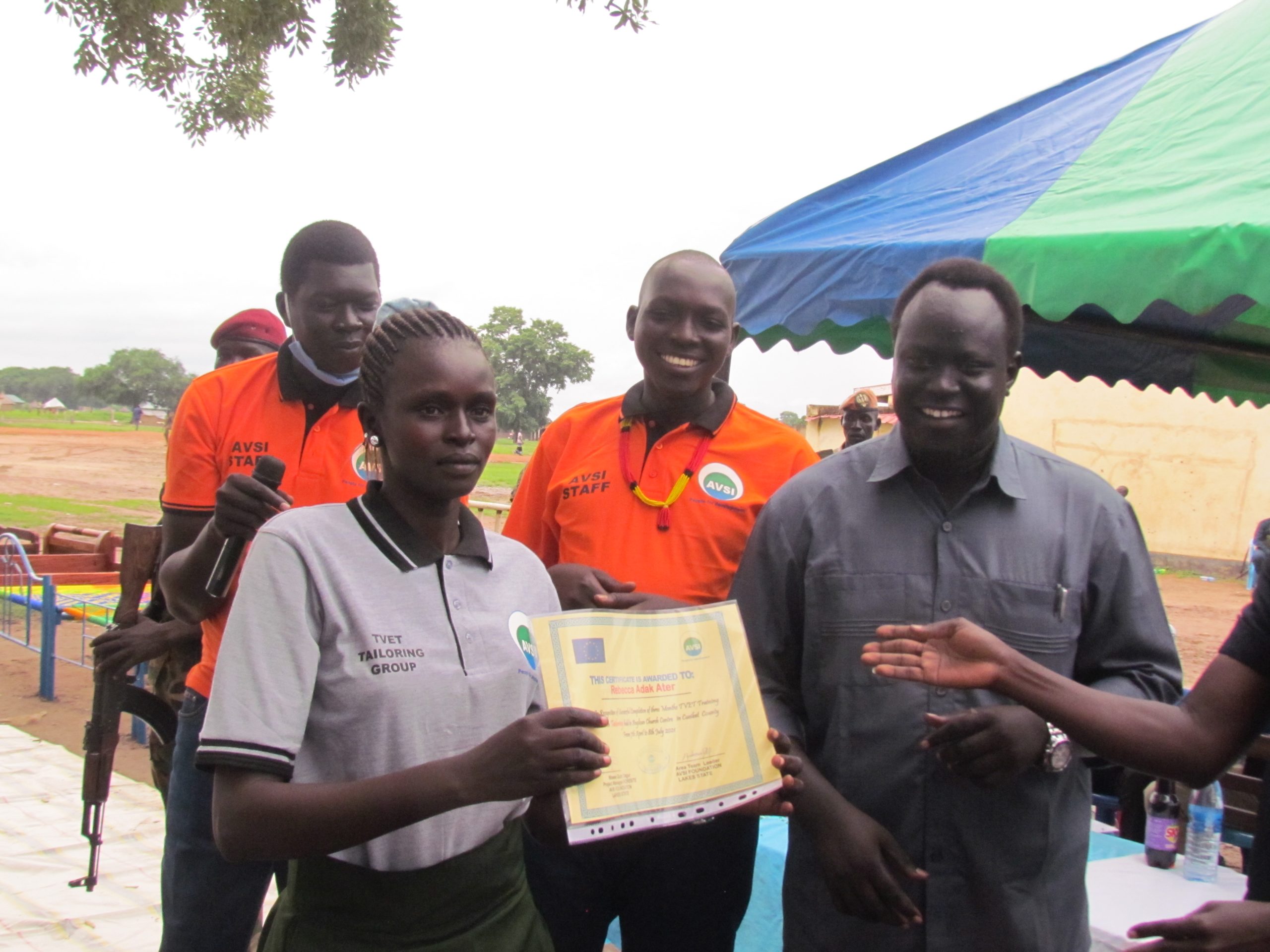 Moses Gum - A-female-Tailoring-TVET-student-receives-her-Certificate-with-excitement-after-being-trained-by-AVSI-in-Cueibet-lake-state-in-2021-credit-Marial
