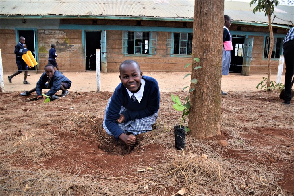 A young girl posing during the 50 year Tree Planting activity