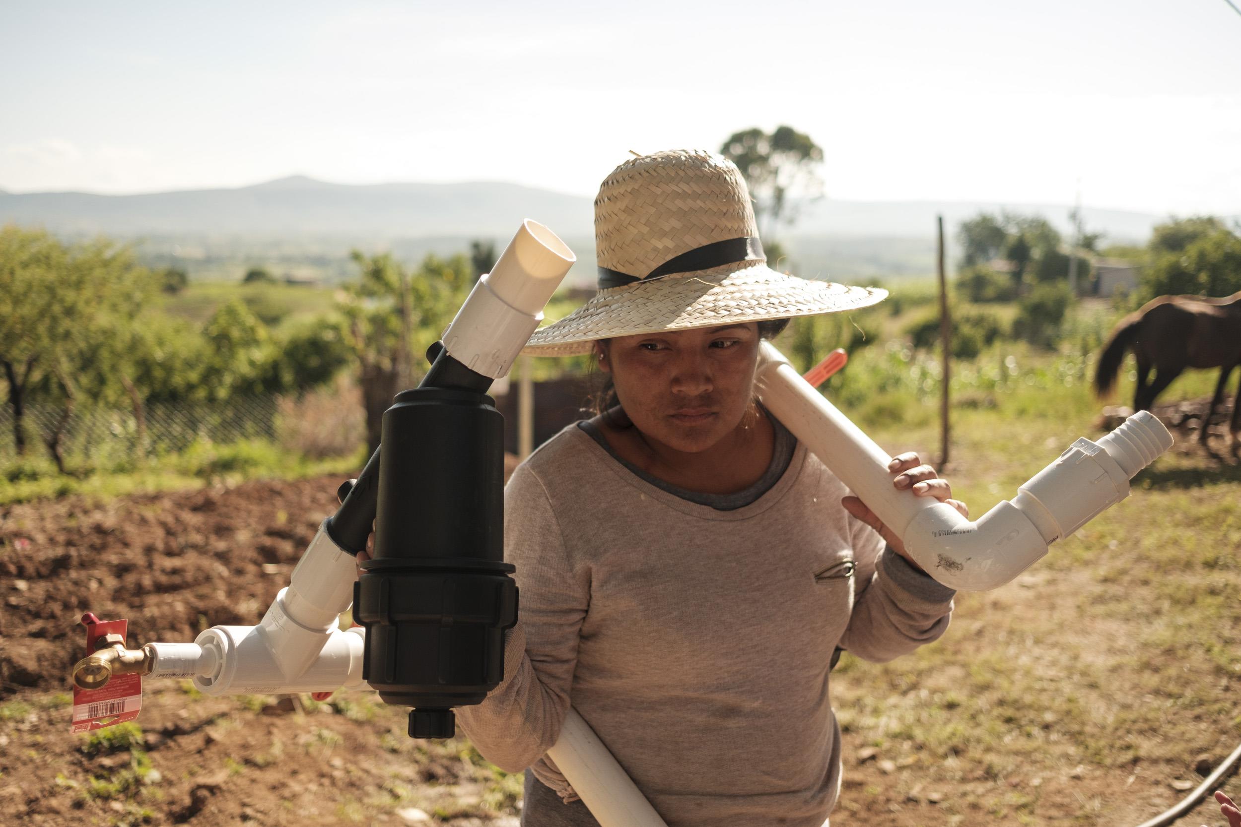 Mexico, A woman is seen carrying a water filtration system
